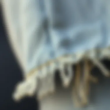 Close-up of fabric texture and ripped hem detail